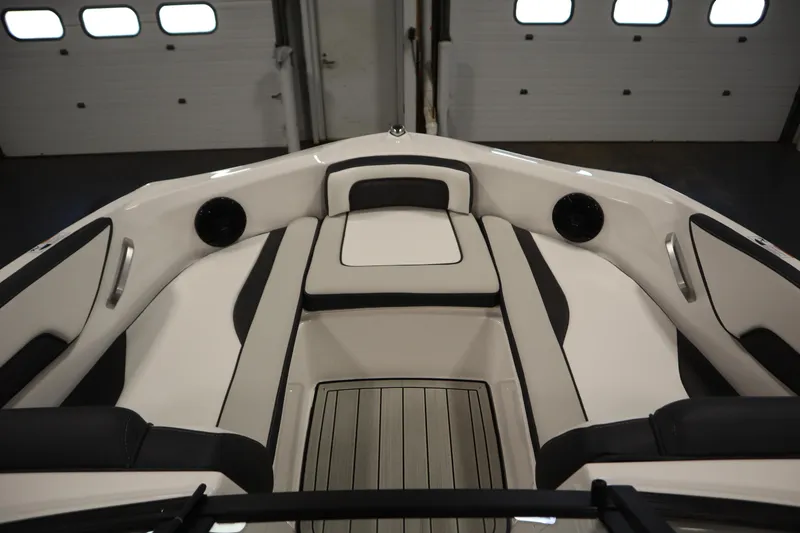 Slide: The Image of 2026 Yamaha Boats 195S interior, featuring sleek seating and modern design in a showroom setting. - 10