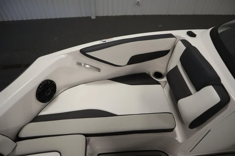 Slide: The Image of 2026 Yamaha Boats 195S interior seating with black and white upholstery, featuring a speaker and cup holder. - 13