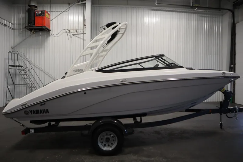 Slide: The Image of 2026 Yamaha Boats 195S in a showroom, side view on a trailer. - 3