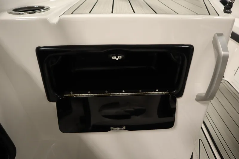 Slide: The Image of 2026 Yamaha Boats 195S storage compartment with sleek black finish and modern design. - 31