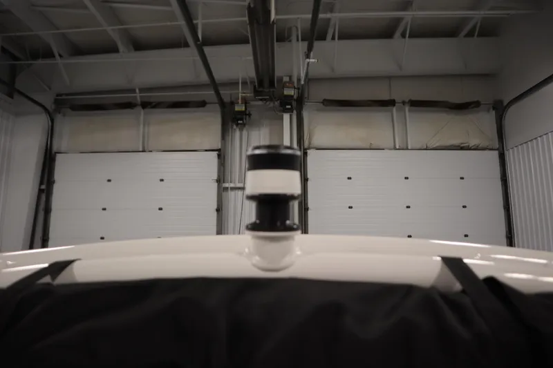 Slide: The Image of 2026 Yamaha Boats 195S in a garage, focus on the boat's top section. - 38