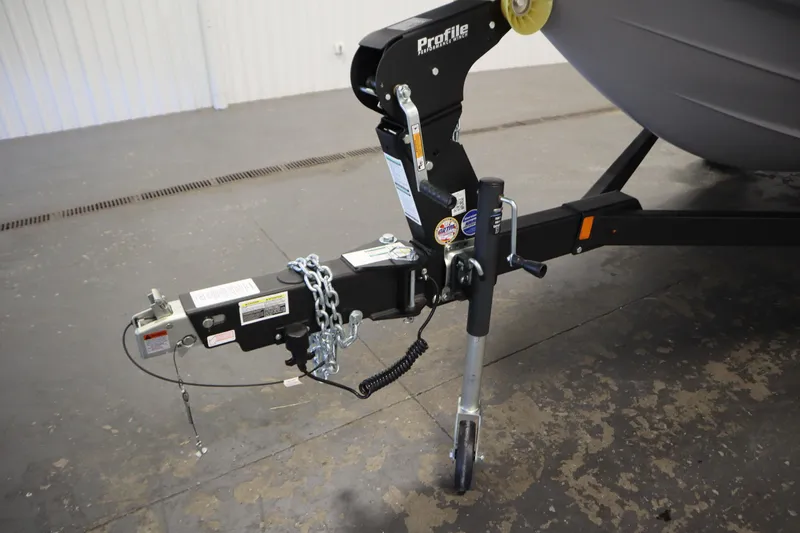 Slide: The Image of Trailer hitch of 2026 Yamaha Boats 195S, featuring secure chains and a sturdy jack stand. - 43