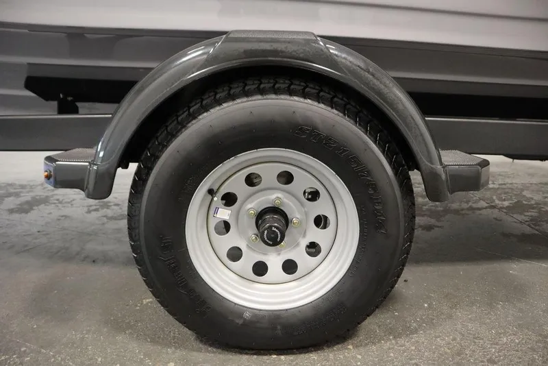 Slide: The Image of Trailer wheel of 2026 Yamaha Boats 195S, featuring a sturdy tire and metal rim. - 47