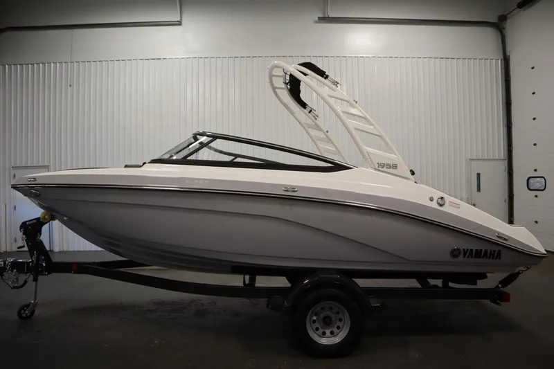 Slide: The Image of 2026 Yamaha Boats 195S in showroom, side view on trailer. - 7