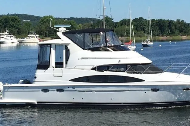 The Image of 2001 Carver 444 Cockpit Motor Yacht cruising on a serene lake. - 0