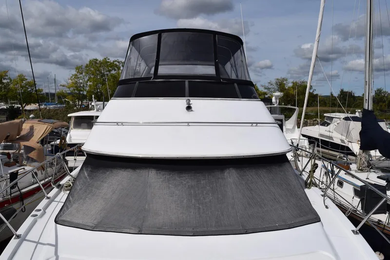 Slide: The Image of 2001 Carver 444 Cockpit Motor Yacht docked, featuring sleek design and spacious cockpit. - 11