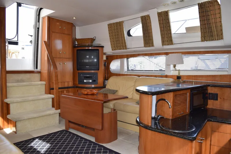 Slide: The Image of Luxurious interior of 2001 Carver 444 Cockpit Motor Yacht with cozy seating and modern amenities. - 16