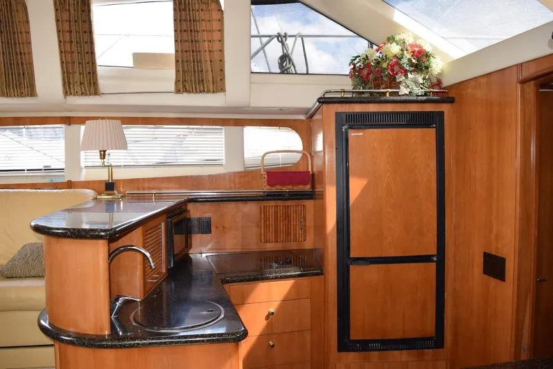 Slide: The Image of Luxurious interior of 2001 Carver 444 Cockpit Motor Yacht with elegant wood finishes. - 18