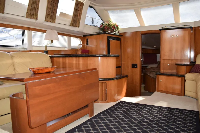 Slide: The Image of Luxurious interior of 2001 Carver 444 Cockpit Motor Yacht with elegant wood finishes. - 19