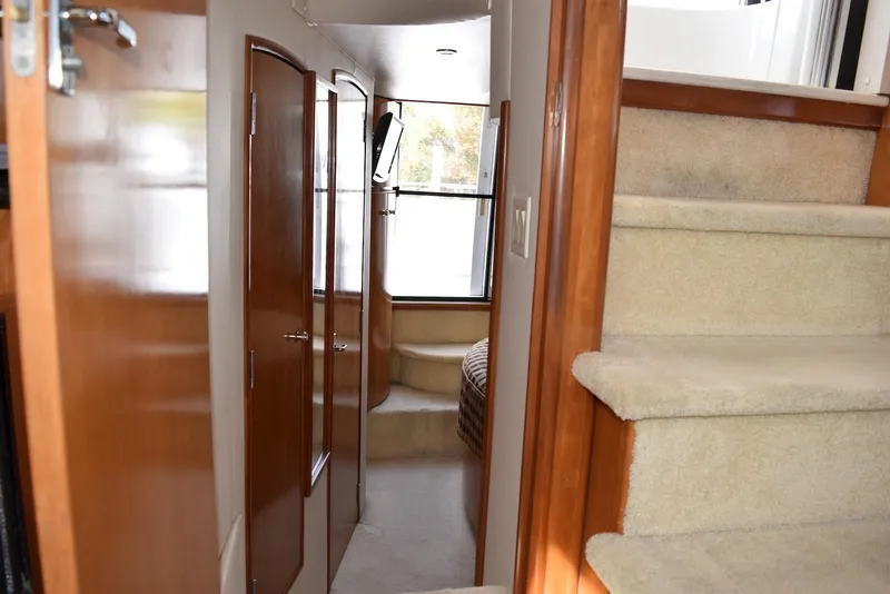 Slide: The Image of Interior of 2001 Carver 444 Cockpit Motor Yacht with carpeted stairs and wooden doors. - 21