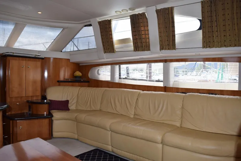Slide: The Image of Luxurious interior of 2001 Carver 444 Cockpit Motor Yacht with leather seating and wood accents. - 22