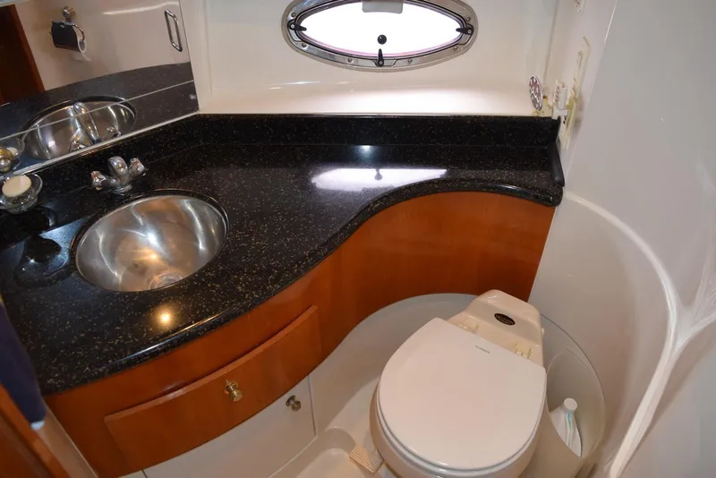 Slide: The Image of Luxurious bathroom in 2001 Carver 444 Cockpit Motor Yacht with sleek countertop and porthole window. - 25