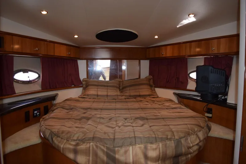 Slide: The Image of Luxurious bedroom interior of 2001 Carver 444 Cockpit Motor Yacht with cozy bedding. - 28