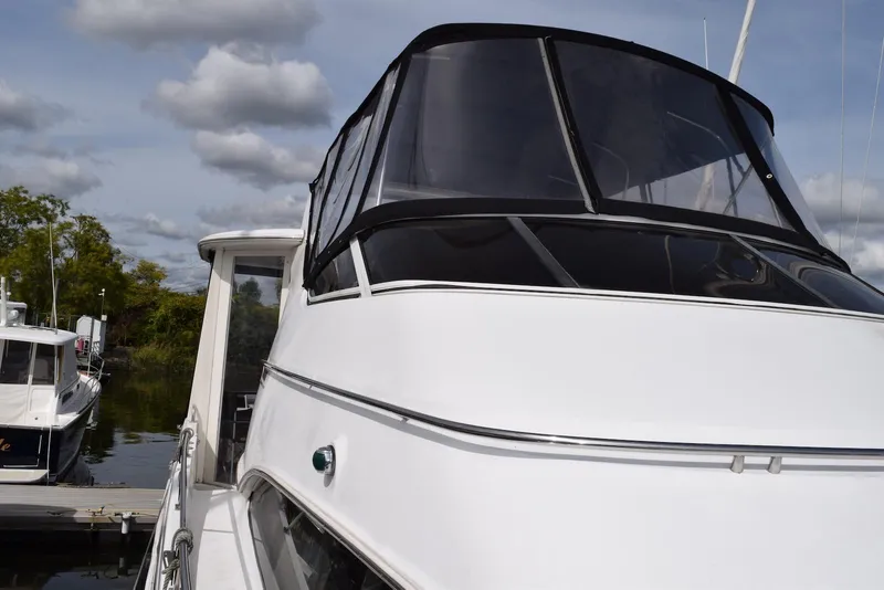 Slide: The Image of 2001 Carver 444 Cockpit Motor Yacht docked under cloudy sky. - 3