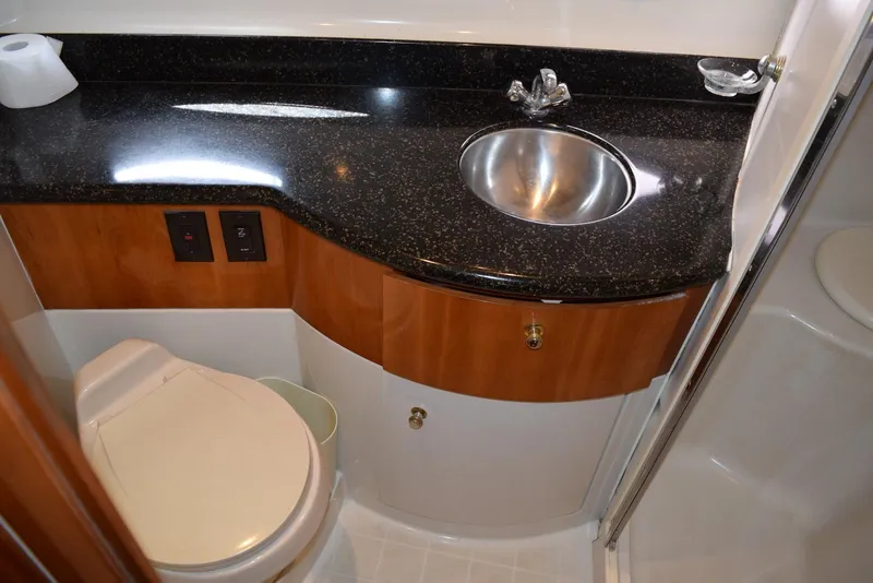 Slide: The Image of 2001 Carver 444 Cockpit Motor Yacht bathroom with sink, toilet, and granite countertop. - 31