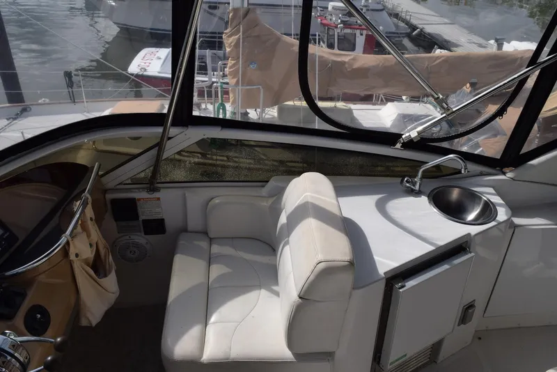 Slide: The Image of 2001 Carver 444 Cockpit Motor Yacht interior with white seating and sink. - 6