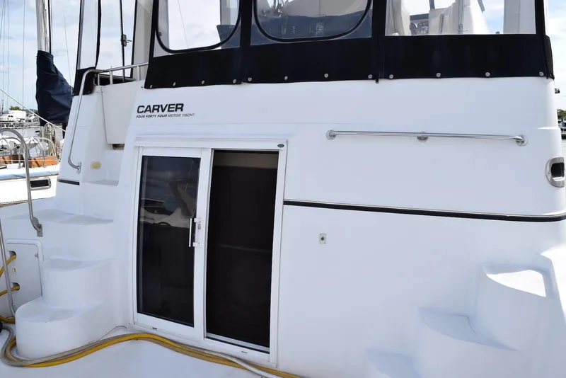 Slide: The Image of 2001 Carver 444 Cockpit Motor Yacht with sliding door and steps, docked at marina. - 7