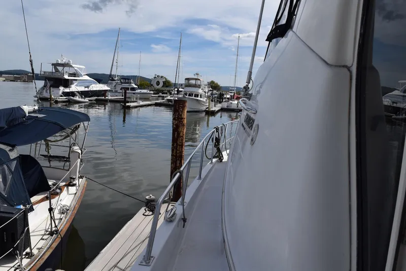Slide: The Image of 2001 Carver 444 Cockpit Motor Yacht docked at a marina with other boats. - 10