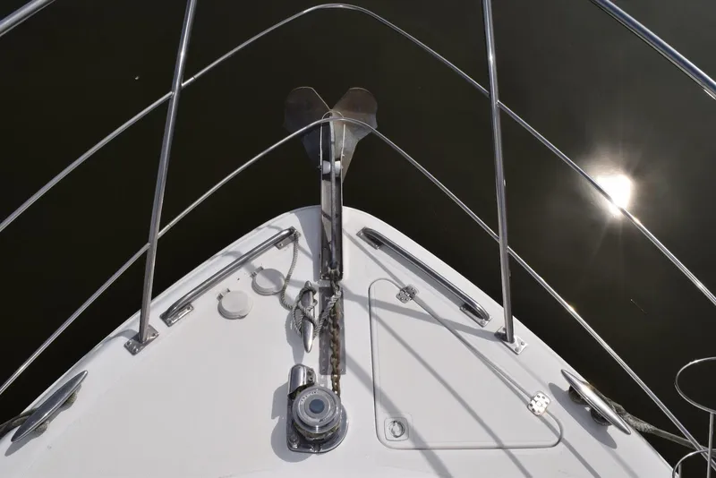 Slide: The Image of Bow view of 2001 Carver 444 Cockpit Motor Yacht with anchor and sun reflection. - 12