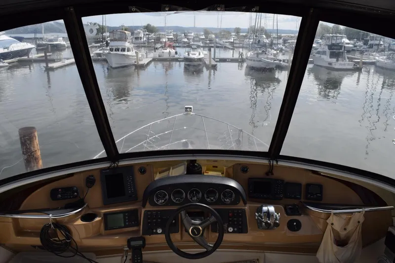 Slide: The Image of Cockpit view of 2001 Carver 444 Cockpit Motor Yacht in marina setting. - 15