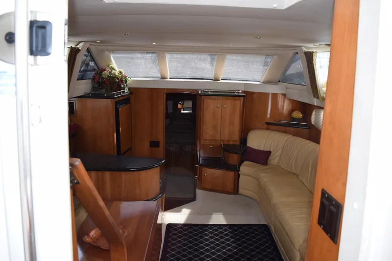 Slide: The Image of Interior of 2001 Carver 444 Cockpit Motor Yacht with elegant wood finish and cozy seating. - 20