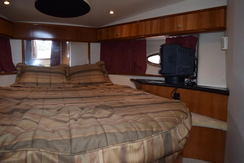 Slide: The Image of Interior of 2001 Carver 444 Cockpit Motor Yacht with cozy bed and TV. - 27