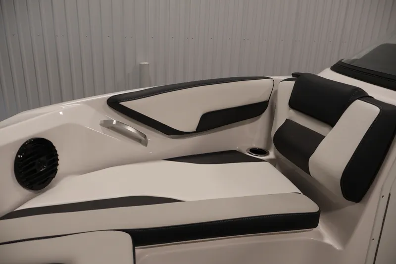 Slide: The Image of 2026 Yamaha Boats 195S interior seating with black and white upholstery, speaker, and cup holder. - 13