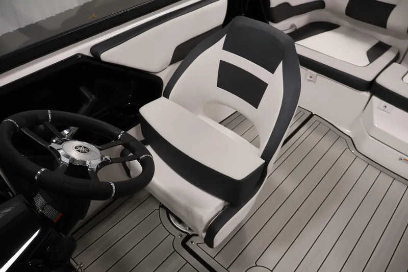 Slide: The Image of 2026 Yamaha Boats 195S interior with sleek steering wheel and modern seating design. - 27
