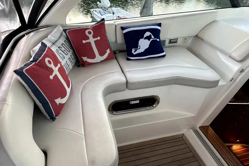 Slide: The Image of Luxurious 2014 PURSUITE 385 yacht interior with nautical-themed cushions and elegant seating. - 5