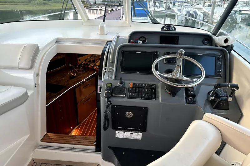 Slide: The Image of Cockpit of 2014 PURSUITE 385 boat with steering wheel and navigation equipment. - 6
