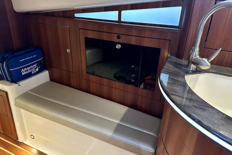 Slide: The Image of Interior of 2014 PURSUITE 385 boat with medical kit, seating, and sink. - 7