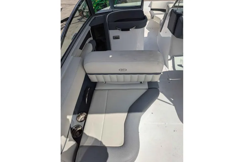 Slide: The Image of 2020 Cobalt 25SC boat interior with cushioned seating and cup holders. - 10