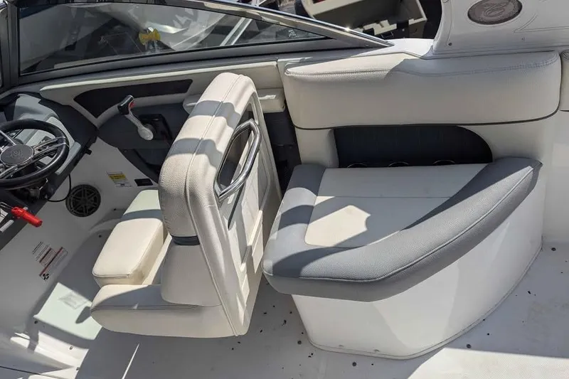 Slide: The Image of Interior of a 2020 Cobalt 25SC boat featuring steering wheel and seating area. - 11