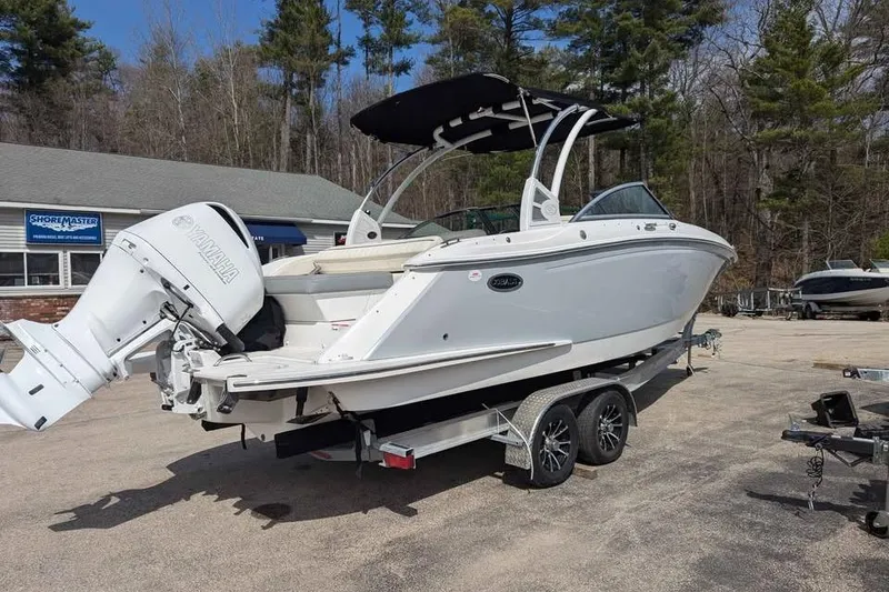 Slide: The Image of 2020 Cobalt 25SC boat on trailer with Yamaha outboard motor, parked outdoors. - 4