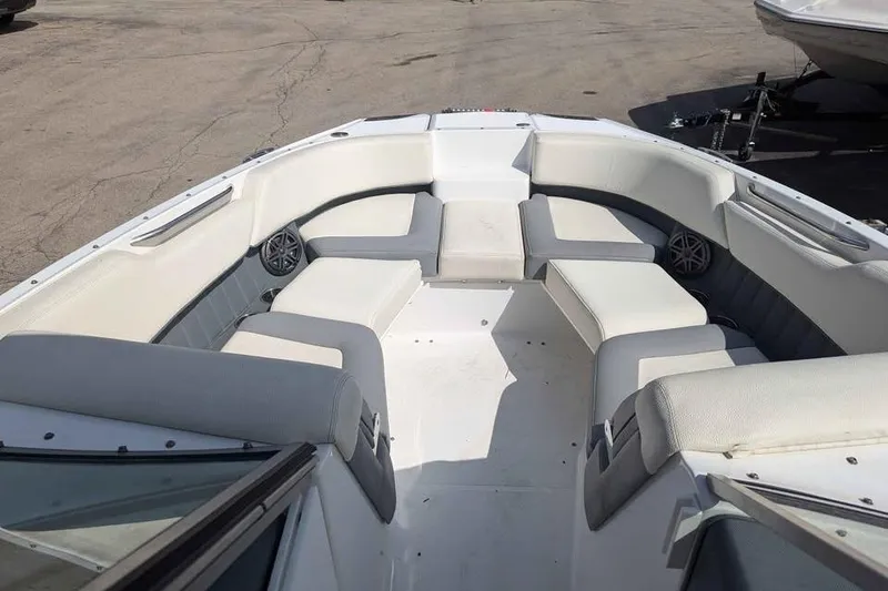 Slide: The Image of 2020 Cobalt 25SC boat interior with white seating and speakers. - 6