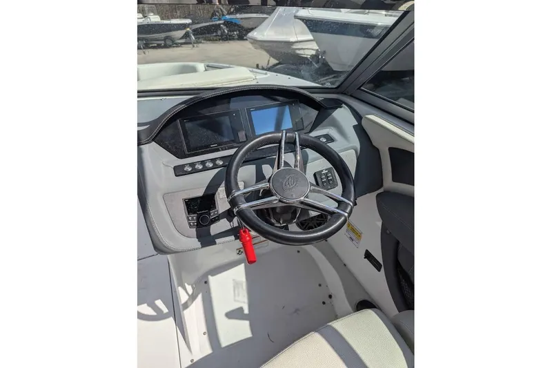 Slide: The Image of 2020 Cobalt 25SC boat dashboard with steering wheel and control panel. - 7