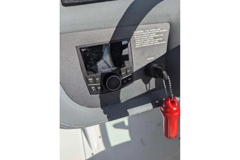 Slide: The Image of 2020 Cobalt 25SC boat dashboard with Rockford Fosgate audio system and ignition switch. - 9