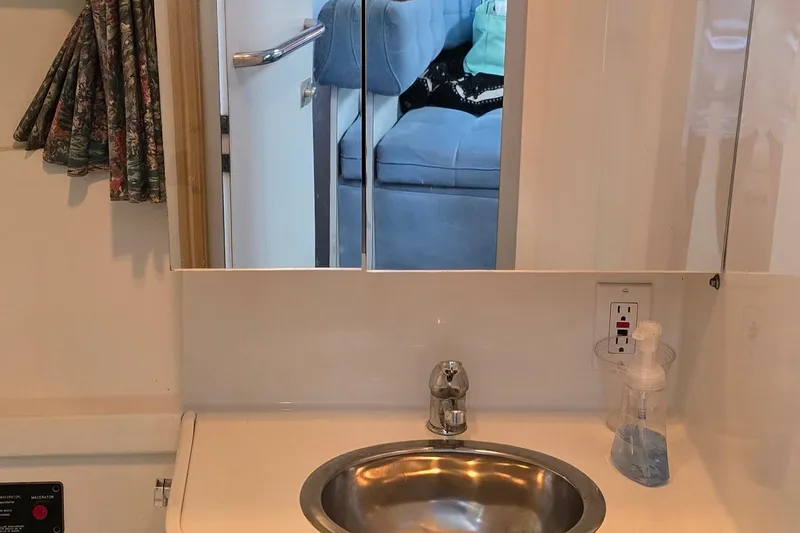 Slide: The Image of Interior of 1995 Formula 34 Performance Cruiser with sink and mirror reflection. - 22