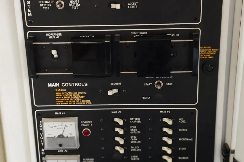 Slide: The Image of Control panel of a 1995 Formula 34 Performance Cruiser boat with various switches and warnings. - 23