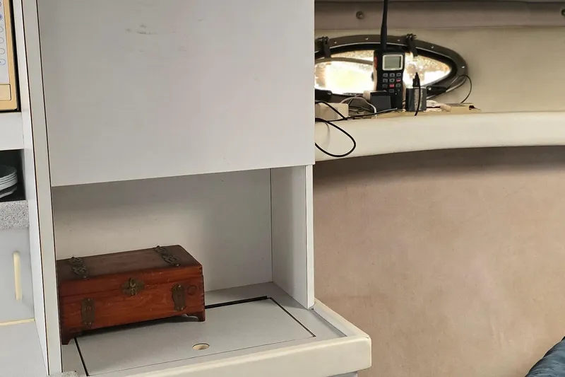 Slide: The Image of Interior of a 1995 Formula 34 Performance Cruiser with wooden box and communication equipment. - 25