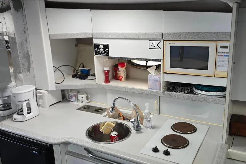 Slide: The Image of Compact kitchen in a 1995 Formula 34 Performance Cruiser with microwave and stove. - 29