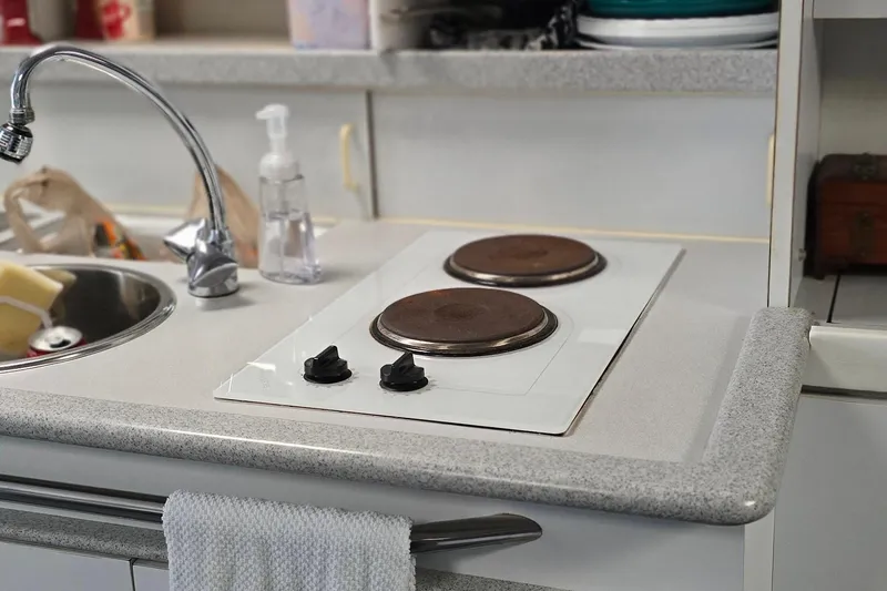 Slide: The Image of Compact kitchen area in a 1995 Formula 34 Performance Cruiser with stove and sink. - 30