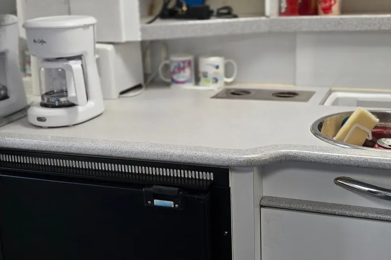Slide: The Image of Kitchen area of a 1995 Formula 34 Performance Cruiser with coffee maker and sink. - 31