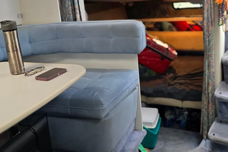 Slide: The Image of Interior of a 1995 Formula 34 Performance Cruiser with blue seating and cozy cabin space. - 32