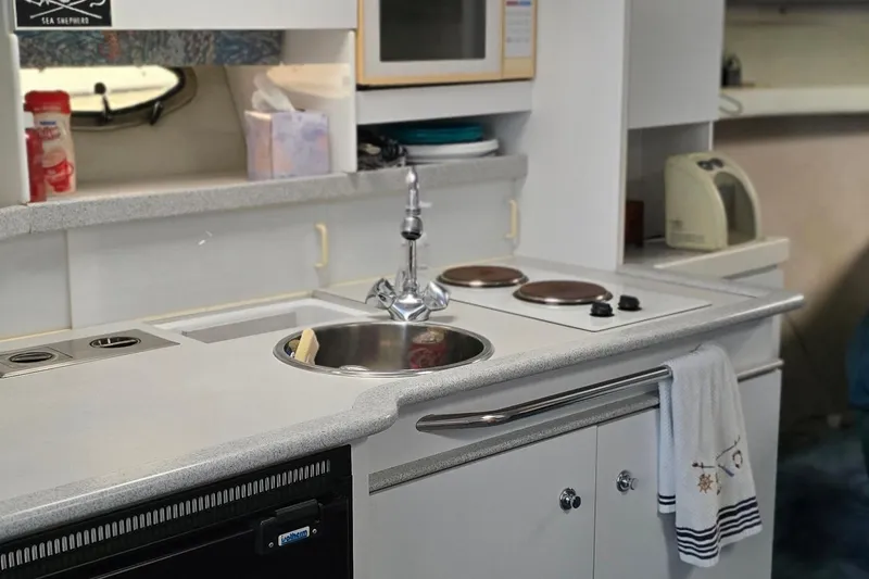 Slide: The Image of 1995 Formula 34 Performance Cruiser kitchen with sink, stove, and microwave. - 33