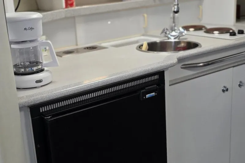 Slide: The Image of 1995 Formula 34 Performance Cruiser kitchen with coffee maker and sink. - 34