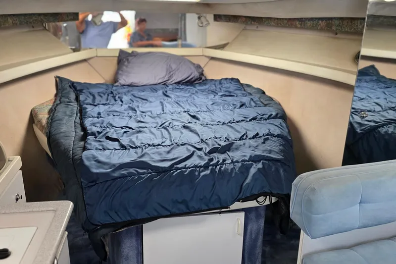 Slide: The Image of 1995 Formula 34 Performance Cruiser interior with cozy bed and blue bedding. - 35