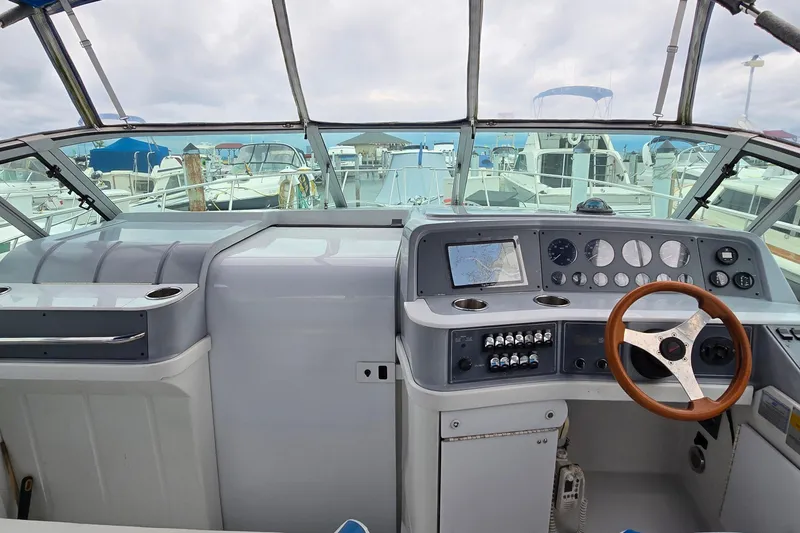 Slide: The Image of 1995 Formula 34 Performance Cruiser cockpit with steering wheel and navigation instruments. - 6