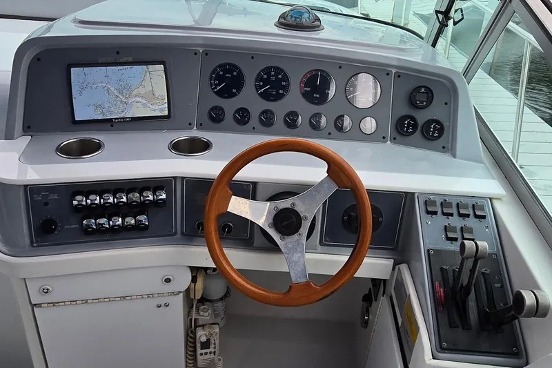 Slide: The Image of 1995 Formula 34 Performance Cruiser helm with wooden steering wheel and navigation instruments. - 7