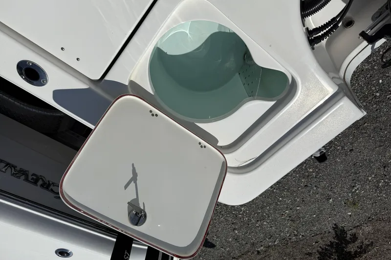 Slide: The Image of 2023 Sea Pro 228 Bay boat livewell with open lid, showcasing interior design. - 10